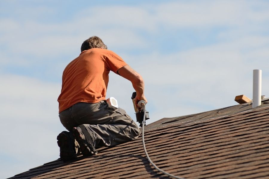 Roofing Contractor repairing a shingle roof