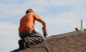 Roofing Contractor repairing a shingle roof
